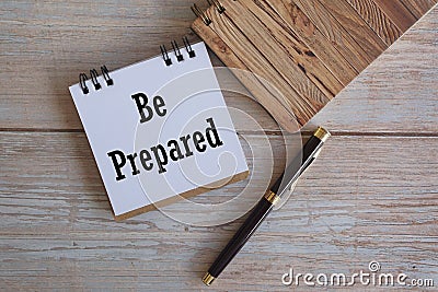 note and pen on wooden background with motivational qoute. Stock Photo