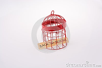 Note about school placed in a red bird house cage with metal bar Stock Photo