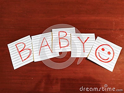 A note writing, caption, inscription Baby reminder or advice on a note in wooden table Stock Photo