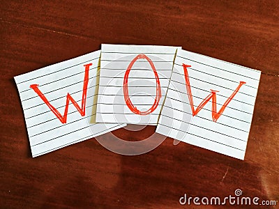 A note writing, caption, inscription Wow reminder or advice on a note in wooden table Stock Photo