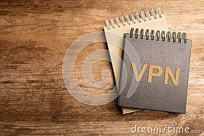 Notebook with acronym VPN and space for text on wooden table, top view. Secure network connection Stock Photo
