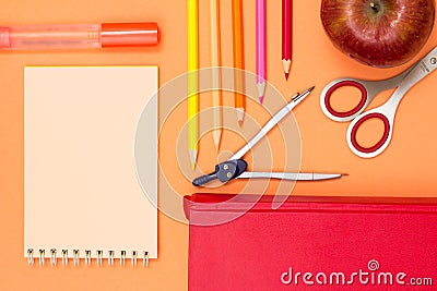 Notebook, book, compass, color pencils and apple on pink background Stock Photo