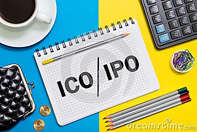 A Notebook with Business notes initial coin offering ICO vs IPO Initial Public Offering with office tools Stock Photo