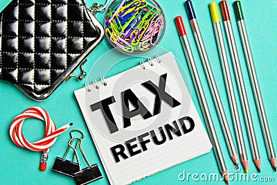 Notebook with a Business notes TAX REFUND on the office table with tools. Concept TAX REFUND. Stock Photo