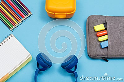 Notebook, color pencils, lunch box, headphones and bag-pencil ca Stock Photo