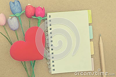 Notebook with colorful artificial tulips heart shape a Stock Photo