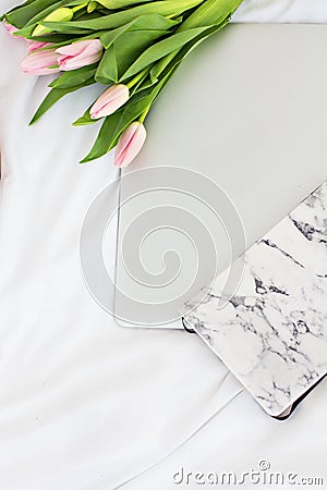 Notebook, diary, a bouquet of pink tulips Stock Photo