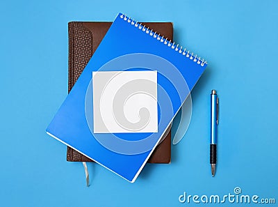 Notebook, diary and pen on blue background. Stock Photo