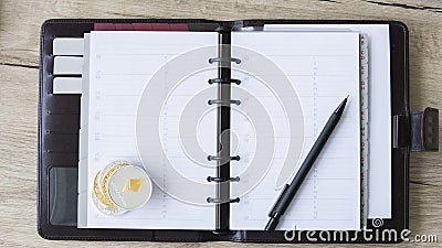 Notebook of Ethereum miner. Ethereum coin and pen on a open notebook. Free space for put a text on a pages. Digital Editorial Stock Photo