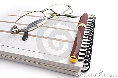 Notebook, glasses and pen Stock Photo