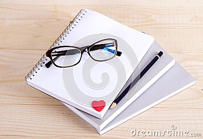 Notebook glasses pencil heart. Stock Photo