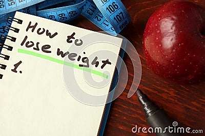 Notebook with how to lose weight sign. Stock Photo