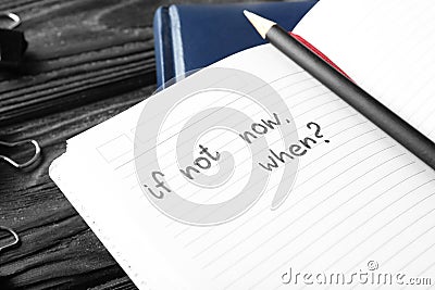 Notebook with inspirational phrase on wooden table Stock Photo