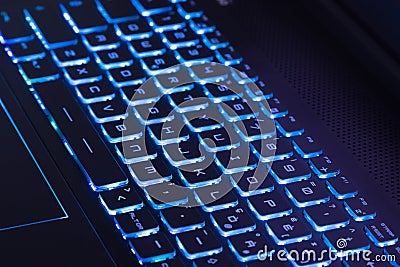 Notebook keyboard with dark blue light tint, technology concept Stock Photo