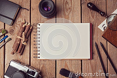 Notebook mock up for artwork or logo design presentation with film camera and lens. View from above Stock Photo