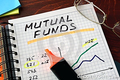 Notebook with mutual funds sign on a table. Stock Photo