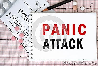 Notebook page with words - PANIC ATTACK nearby with a pills and pencil, medical concept Stock Photo