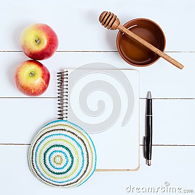 Notebook, pen and kipa on a white wooden background, top view. Jewish New Year, Rosh Hashanah Stock Photo