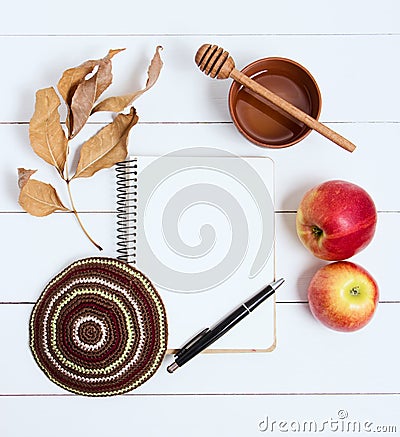 Notebook, pen and kipa on a white wooden background, top view. Jewish New Year, Rosh Hashanah Stock Photo