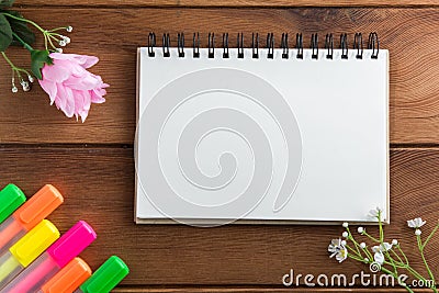 Notebook with a pen wooden floor highlights. Stock Photo