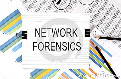 Notebook with pencils, glasses on graph background, with text NETWORK FORENSICS Stock Photo