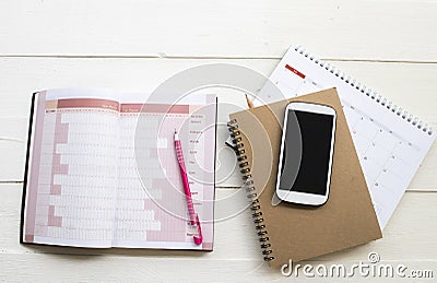 Notebook planner ,calendar and mobile phone for business work Stock Photo