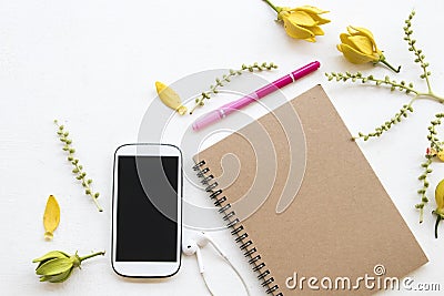 Notebook planner ,mobile phone for business with flower ylang ylang Stock Photo