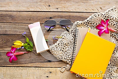 Notebook planner ,sunscreen body lotion, sunglasses and knitting of lifestyle woman relax Stock Photo