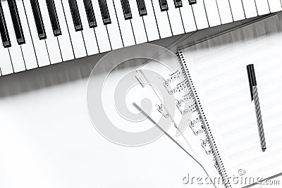 Notebook with synthesizer in music studio for dj or musician work white desk background top view mock-up Stock Photo