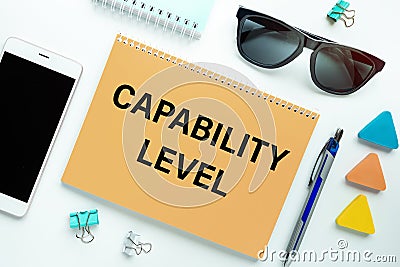 Notebook with text Capability Level near office supplies Stock Photo