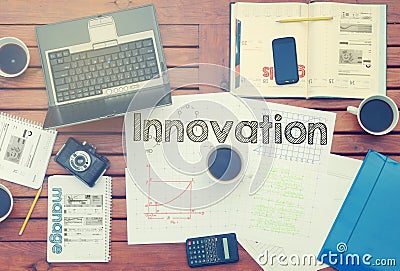 Notebook with text inside Innovation on table with coffee, some Stock Photo