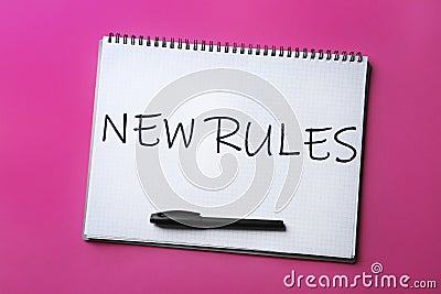 Notebook with text NEW RULES and marker on background, top view Stock Photo