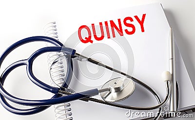 Notebook with text QUINSY with pen and stethoscope Stock Photo