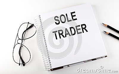 Notebook with text SOLE TRADER on the white background Stock Photo