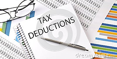 Notebook with text TAX DEDUCTIONS . Diagram and white background,Business concept Stock Photo