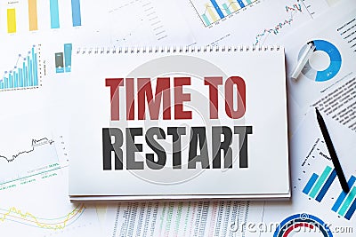 Notebook with Tools and Notes with text TIME TO RESTART Stock Photo