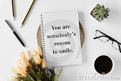 Notebook with wisdom quote and coffee cup. Stock Photo