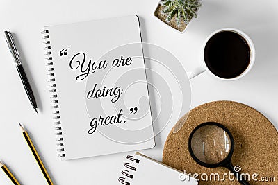 Notebook with wisdom quote and coffee cup. Stock Photo