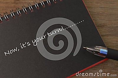 Notebook written with text NOW, IT`S YOUR TURN Stock Photo