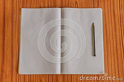 Notebooks and pencil isolated on wooden table hardwood floor. Ready to write notes, reports, messages or letter for student, Stock Photo