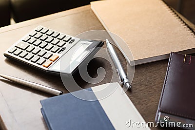 Notebooks, pens and calculator on table Stock Photo