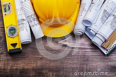 Notepad blueprints hard hat wooden meter and Stock Photo