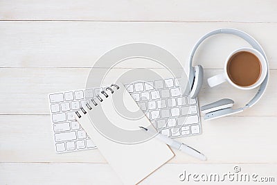 Notepad and computer on white table with headphone. View from ab Stock Photo