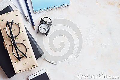 Notepad diary, business card, glasses, clock on a light table. Top view with copy space,Flat Lay Stock Photo