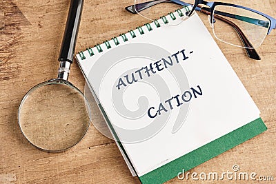 A notepad displays the word authentication, highlighting its importance in security and technology Stock Photo