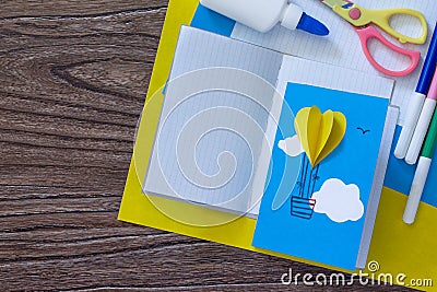 Notepad for entries of handmade balloons and markers decorated with appliquÃ©s, paper on a desk, craft of paper. Stock Photo