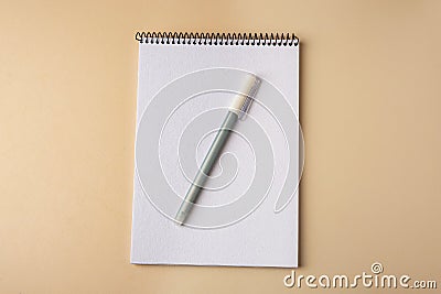 Notepad with erasable pen on beige background, top view Stock Photo