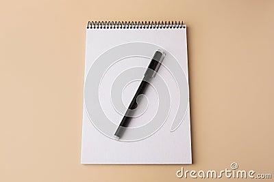 Notepad with erasable pen on beige background, top view Stock Photo