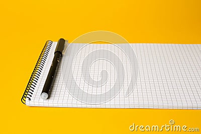Notepad with erasable pen on yellow background, closeup Stock Photo