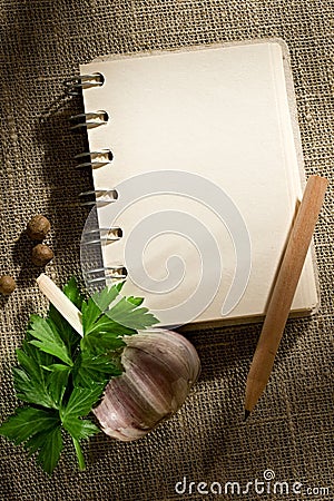 Notepad, garlic, pepper, parsley Stock Photo